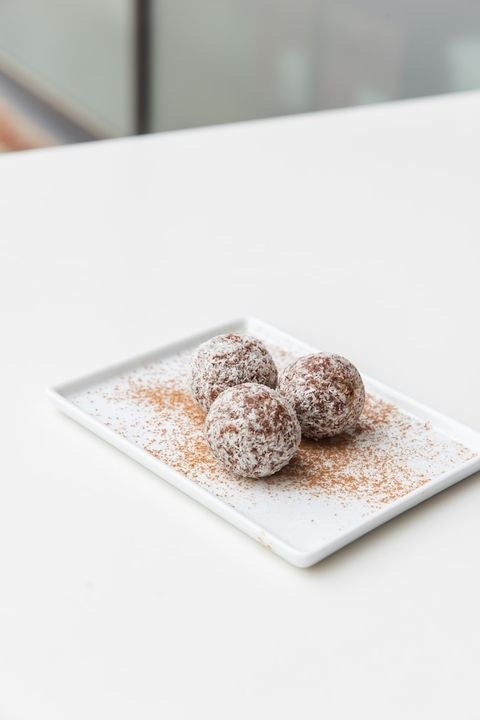 E+ROSE booster bites rolled in coconut flakes with a dusting of cinnamon