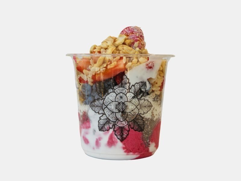 A vibrant E+ROSE smoothie bowl topped with fresh fruit, nuts, and seeds — made entirely without seed oils