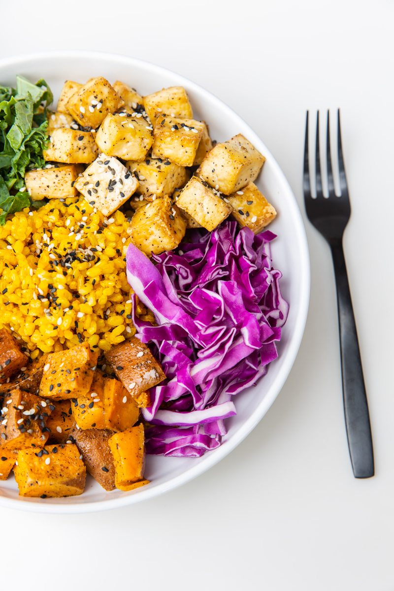 E+ROSE Buddha Bowl — turmeric brown rice, baked tofu, roasted sweet potato, kale, and red cabbage