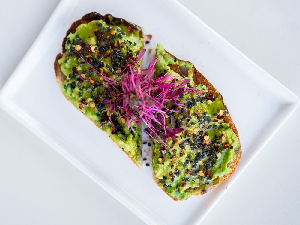 E+ROSE Fire Flour Toast — smashed avocado with chili flakes, black sesame, and microgreens on sourdough